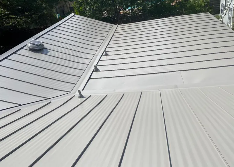 Solar attic fan installed on a metal roof for Roof Ventilation in Lake Arbor